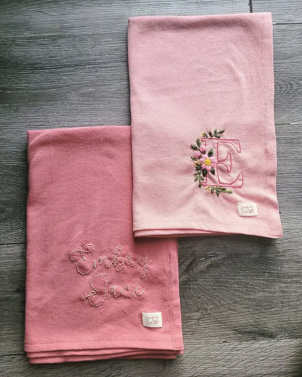 Pink cloths embroidered with a floral monogram