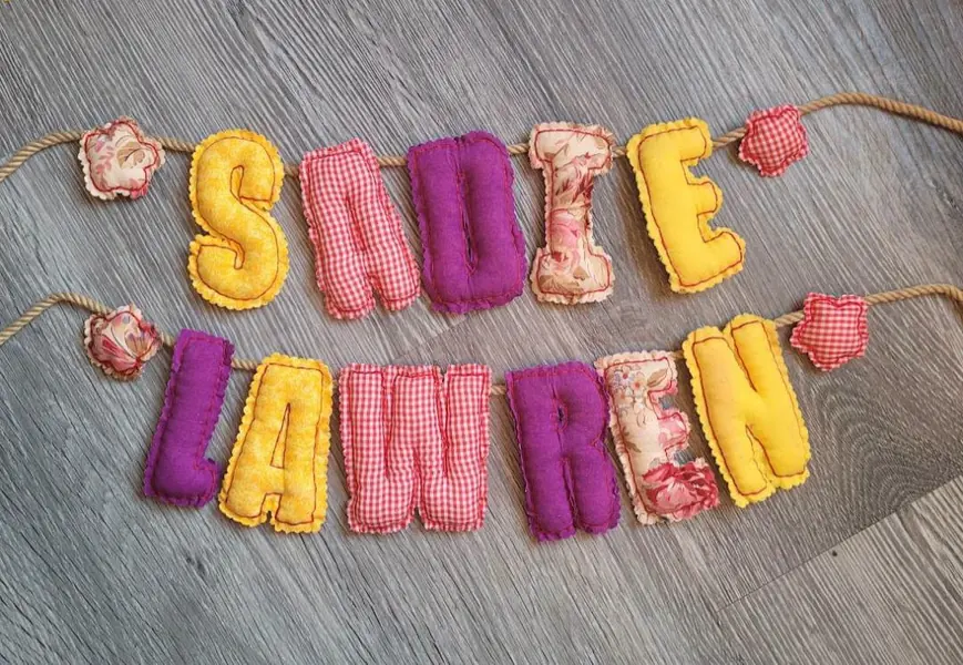 Plush fabric name banner spelling Sadie Lawren
