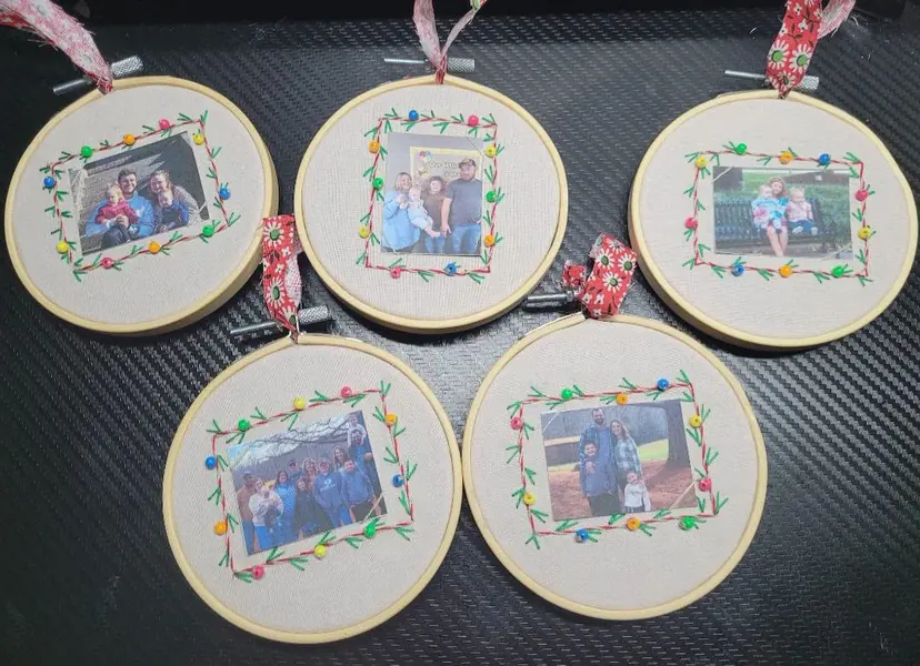 Five embroidery hoops framing family photos with floral borders