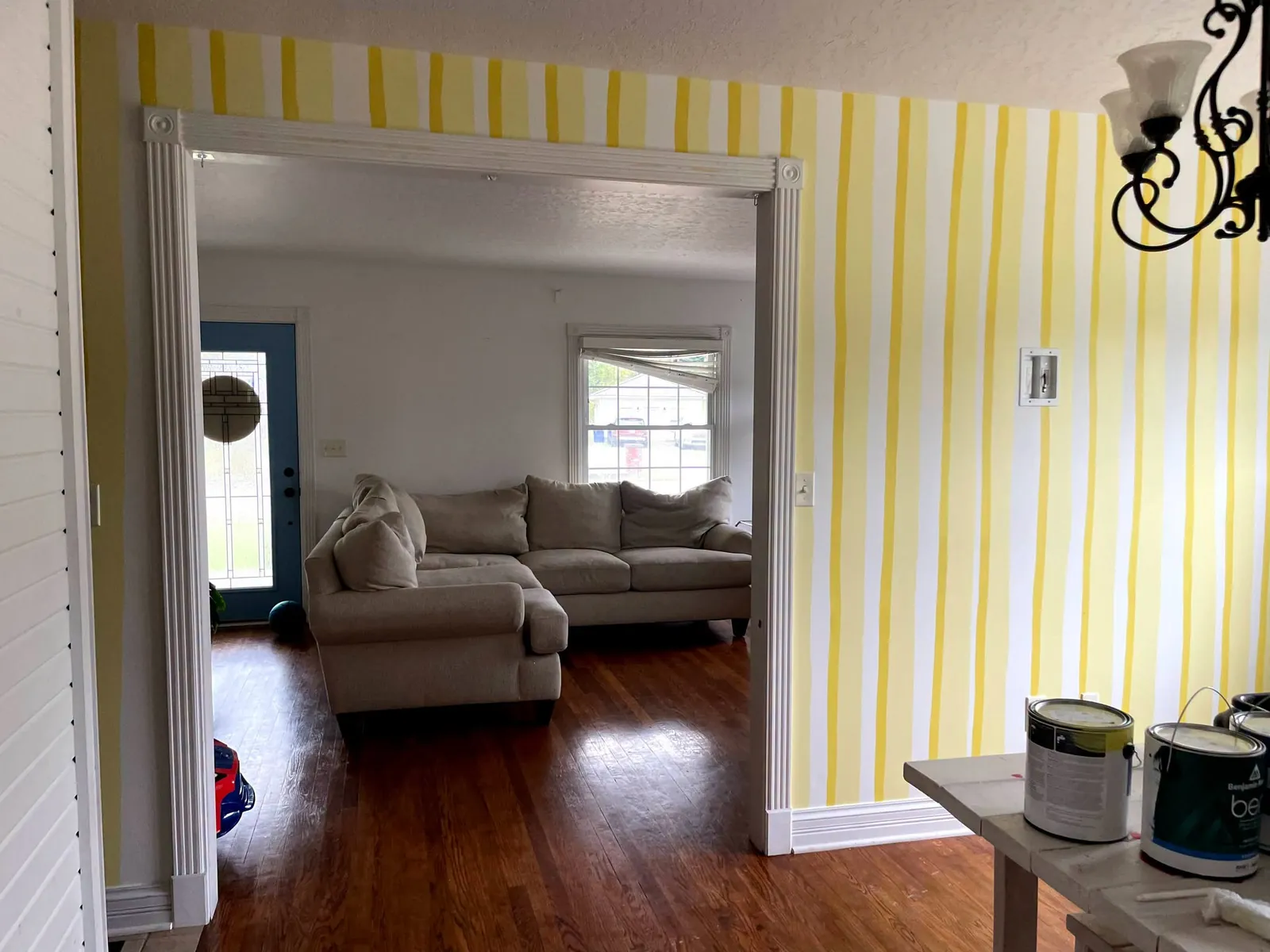 Room painted with yellow and white vertical stripes