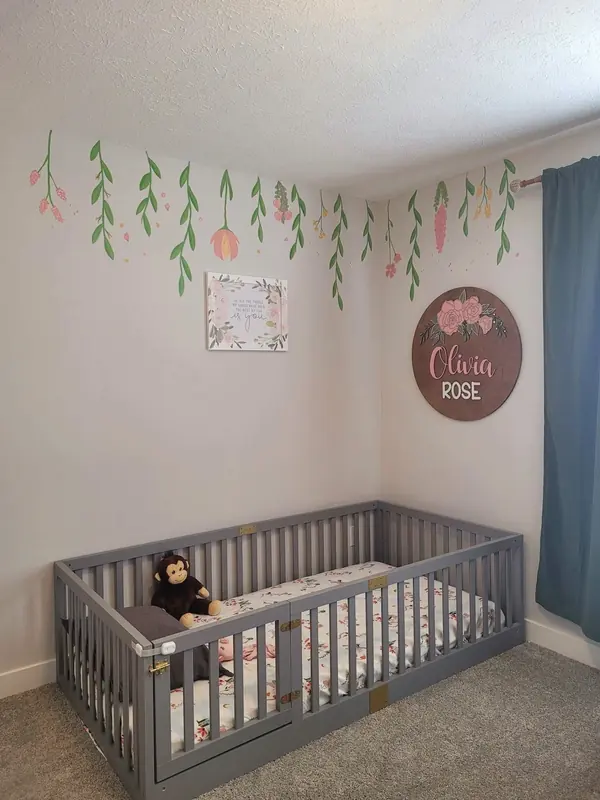 Nursery wall painted with trailing greenery vines