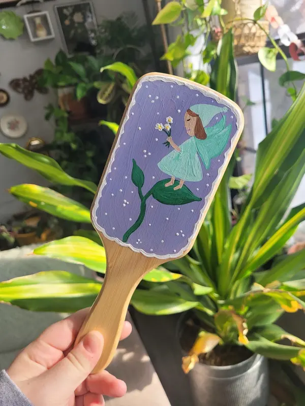 Hairbrush hand-painted with a fairy on a lavender background