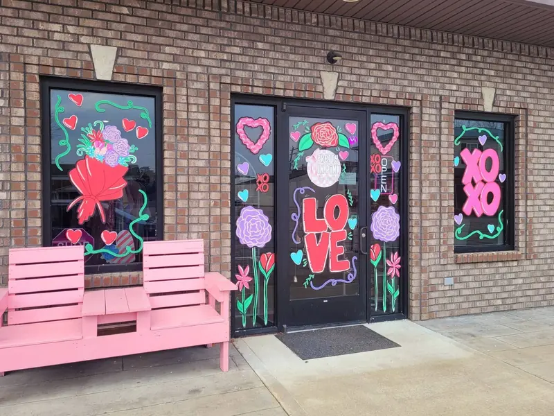 Valentine's storefront windows with LOVE, hearts and XOXO