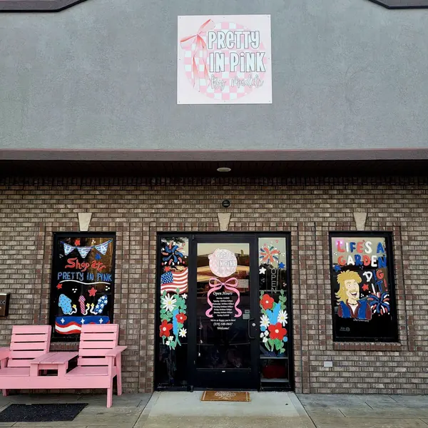 Patriotic storefront windows with a pink bench