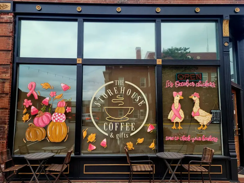 Coffee shop windows painted with pumpkins and geese