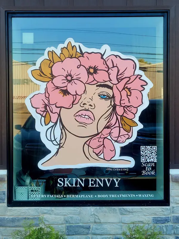 Skin Envy window with a woman's face framed in pink flowers